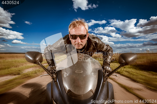 Image of Biker racing on the road