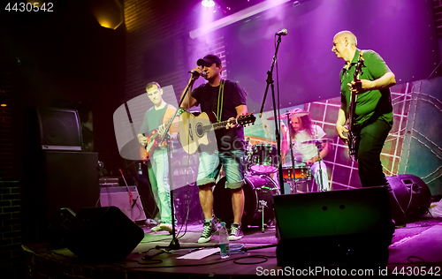 Image of Band performs on stage in a nightclub