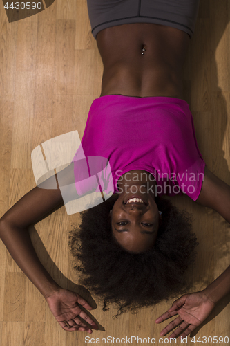 Image of woman  relaxing after pilates workout