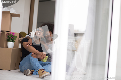 Image of African American couple relaxing in new house