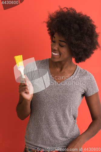 Image of black woman painting wall