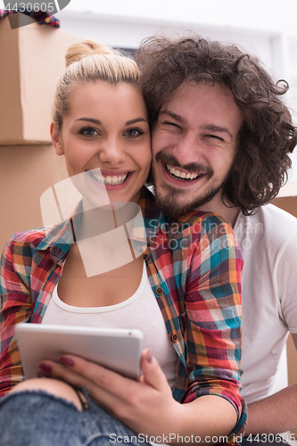 Image of young couple moving  in new house