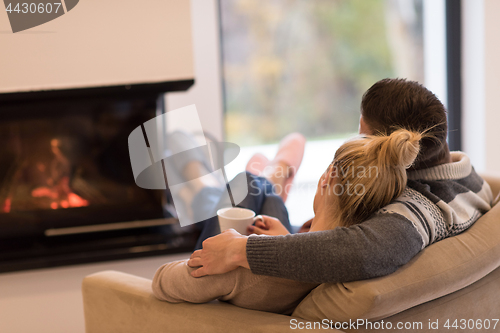 Image of Young couple  in front of fireplace