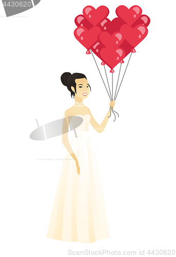 Image of Bride with bunch of heart-shaped red balloons.