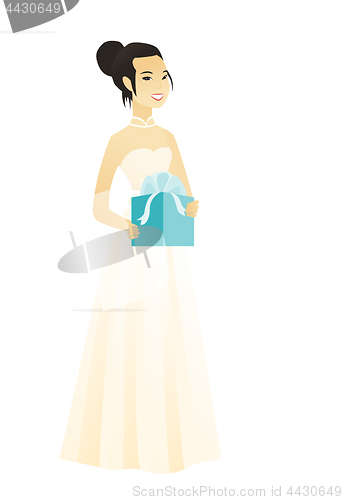 Image of Woman in a white bridal dress holding a gift box.