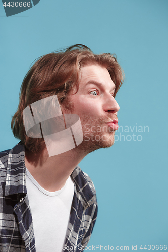 Image of Portrait of attractive cute man with kiss isolated over blue background