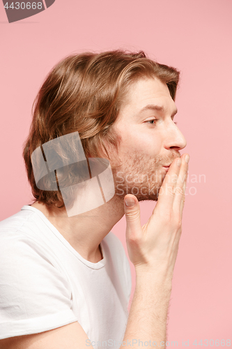 Image of Portrait of attractive cute man with kiss isolated over pink background