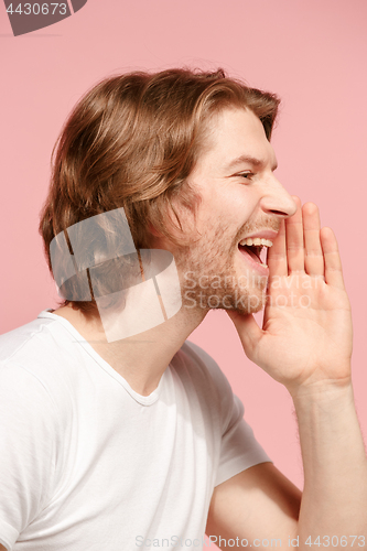 Image of Isolated on pink young casual man shouting at studio