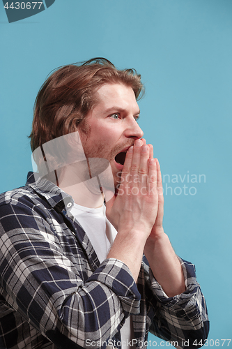 Image of Beautiful man in stress isolated on blue