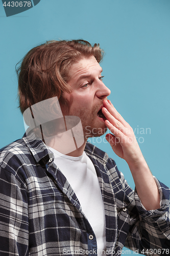 Image of Beautiful bored man bored isolated on blue background