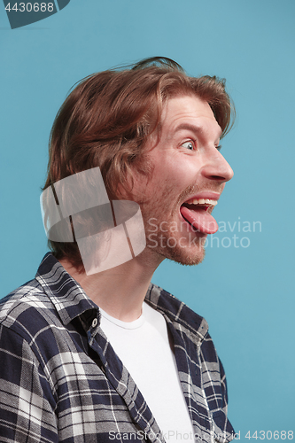 Image of The man with crazy expression isolated on blue