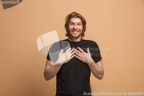 Image of Handsome man looking suprised isolated on pastel