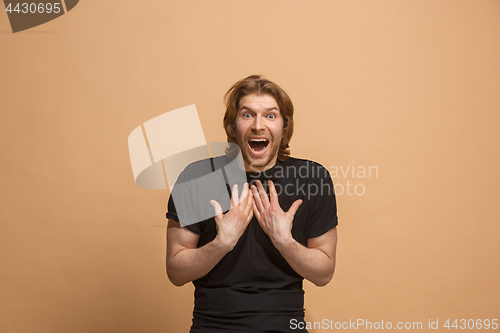 Image of Handsome man looking suprised isolated on pastel