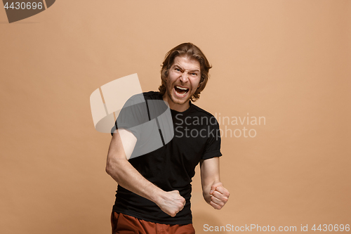 Image of Winning success man happy ecstatic celebrating being a winner. Dynamic energetic image of male model