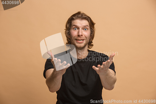 Image of Handsome man looking suprised isolated on pastel