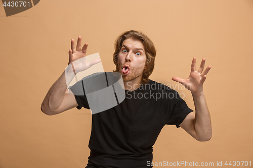 Image of The squint eyed man with weird expression isolated on pastel