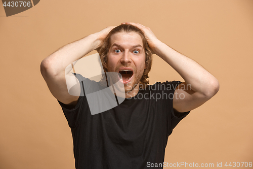 Image of Handsome man looking suprised isolated on pastel