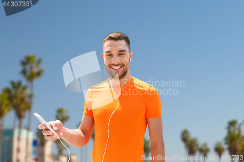 Image of man with smartphone and earphones in los angeles