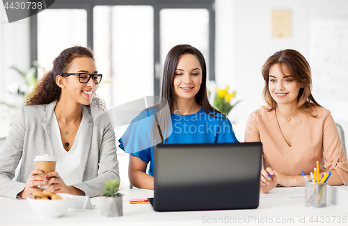 Image of businesswomen with laptop working at office