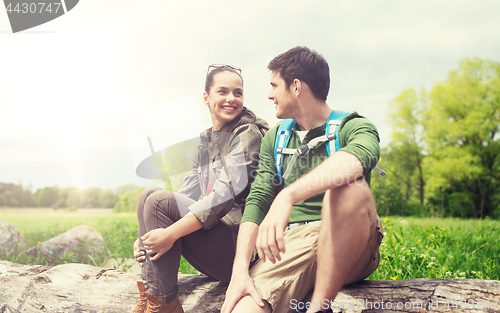 Image of smiling couple with backpacks in nature