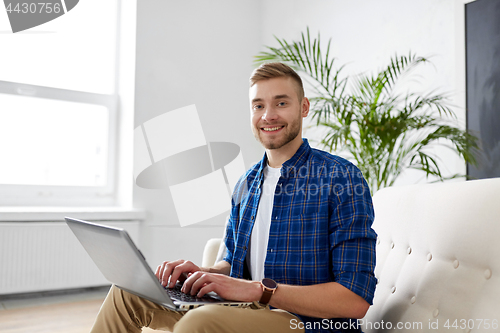 Image of man with laptop working at office