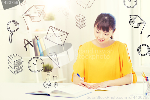 Image of happy asian young woman student learning at home