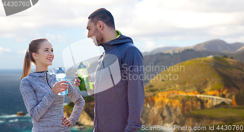 Image of couple of sportsmen with water over big sur coast