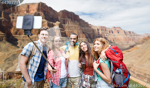 Image of happy travelers taking selfie at grand canyon