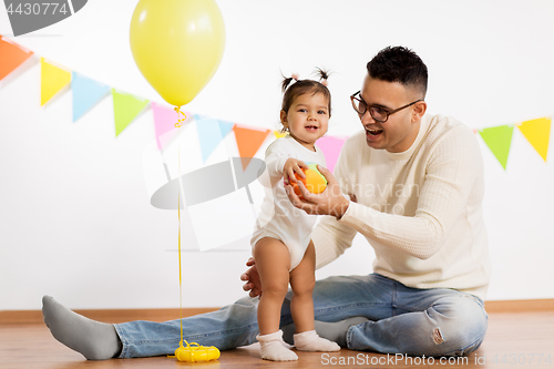 Image of father and daughter with birthday party balloon