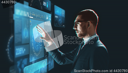 Image of businessman torching virtual screen projection