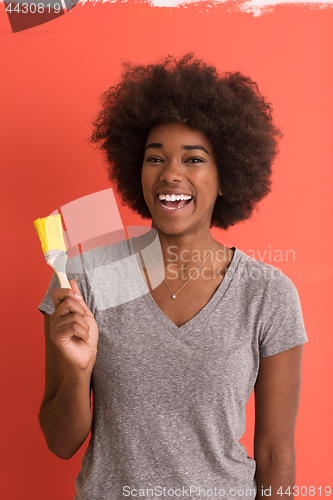 Image of black woman painting wall