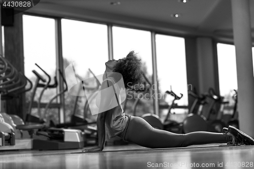 Image of african american woman exercise yoga in gym