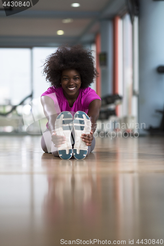 Image of woman in a gym stretching and warming up before workout