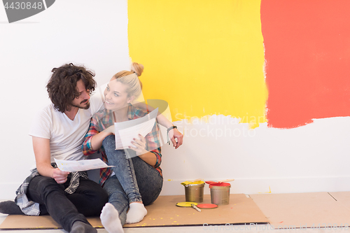 Image of Happy young couple relaxing after painting