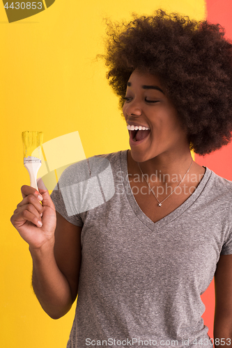 Image of black woman painting wall