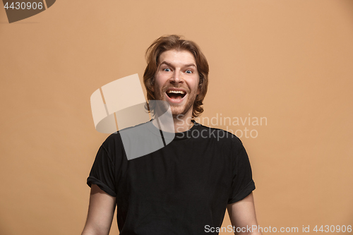 Image of The happy business man standing and smiling against pastel background.