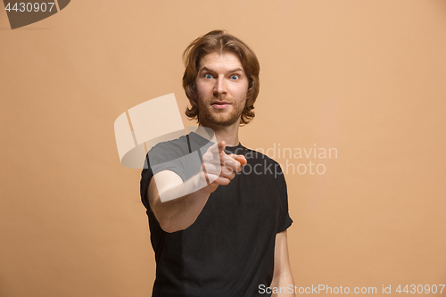 Image of The happy business man point you and want you, half length closeup portrait on pastel background.