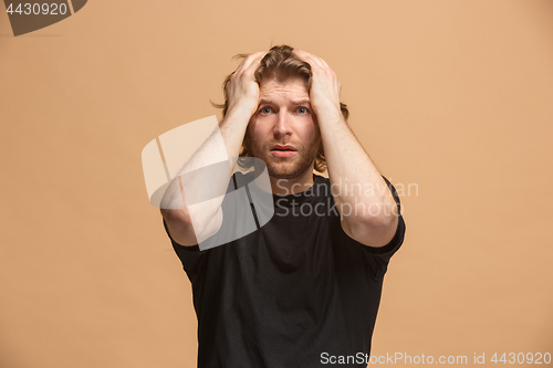 Image of The young emotional angry and scared man standing and looking at camera