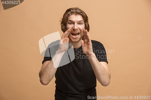 Image of Isolated on pastel young casual man shouting at studio