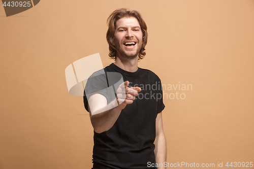 Image of The happy business man point you and want you, half length closeup portrait on pastel background.