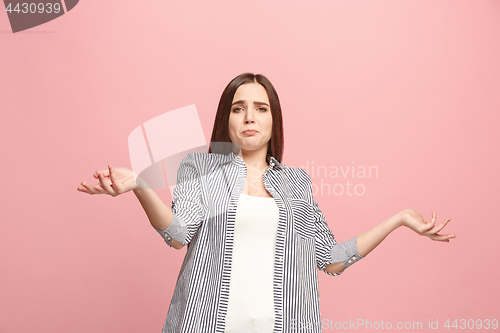 Image of Beautiful female half-length portrait isolated on pink studio backgroud. The young emotional surprised woman