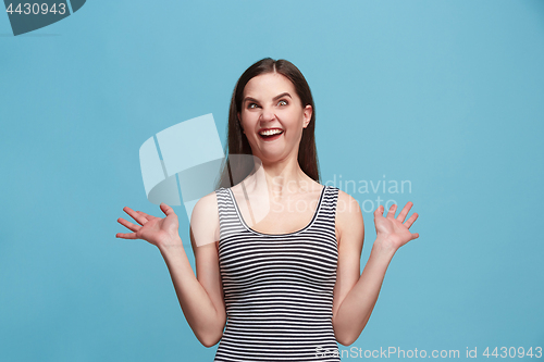 Image of The squint eyed woman with weird expression isolated on blue