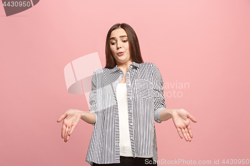 Image of Beautiful female half-length portrait isolated on pink studio backgroud. The young emotional surprised woman