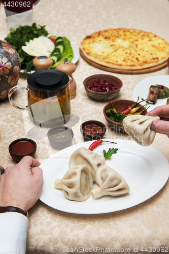 Image of Man eating in georgian restaurant