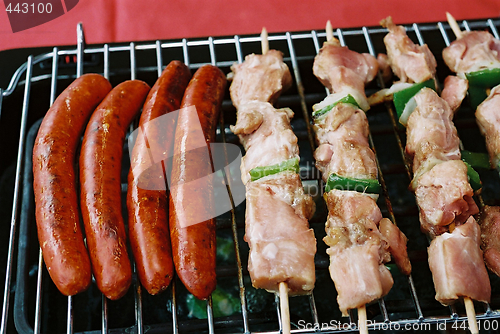 Image of Sausages and kebab on Barbecue BBQ grill