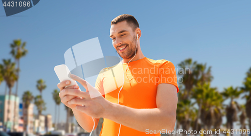 Image of man with smartphone and earphones in los angeles