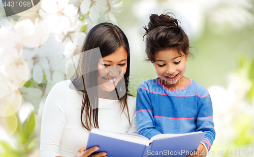 Image of happy mother and daughter reading book