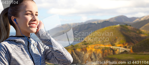 Image of close up of woman listening to music in earphones