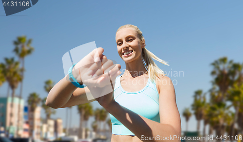 Image of woman with fitness tracker exercising outdoors