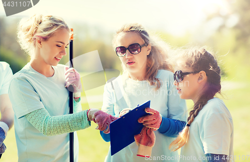 Image of group of volunteers with clipboard in park